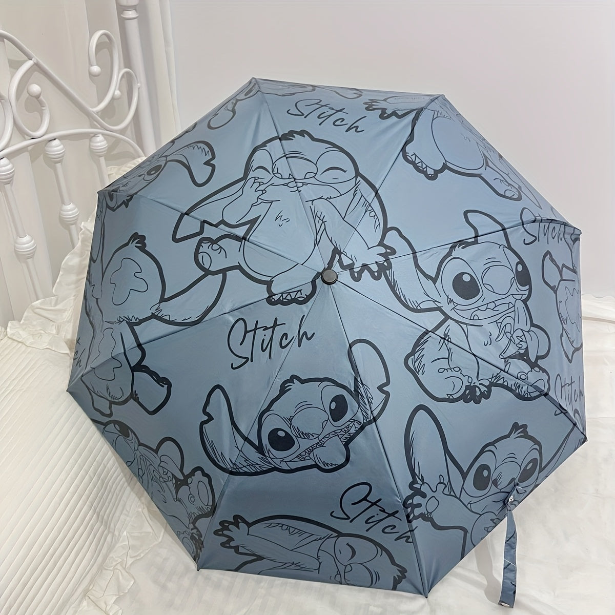A Cartoon Folding Travel Umbrella That Is Waterproof And Windproof, in Light Blue, Featuring Playful Stitching Design, Perfect for School, Shopping, Outdoor Adventures, And Birthdays.